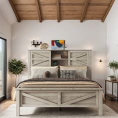 a bedroom with a large bed and wooden beams on the ceiling, along with potted plants