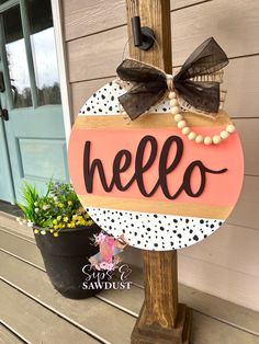 a wooden sign that says hello on it