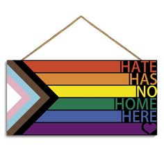 a sign that says hate has no home here with an arrow on the front and rainbow colors