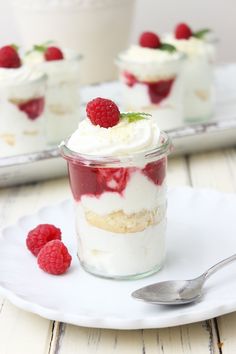 strawberry shortcakes in a jar with whipped cream and strawberries on the side