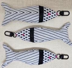 two black and white striped bow ties sitting on top of each other with pink flowers