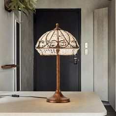 a lamp sitting on top of a table next to a door