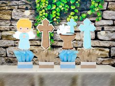 "Christening Baptism centerpieces | Brown Baptism Angel | Christening Decoration | Baptism Religious Theme Centerpiece Decoration INDIVIDUAL These centerpieces feature a WOODEN BASE, DOUBLE SIDED image, and COMPLETELY DECORATED as pictured! Arrive FULLY ASSEMBLED for quick and easy setup, making it an ideal choice for any themed party tablescape. The colors and characters make this centerpiece perfect for adding a fun and festive touch. This listing is to purchase centerpieces individually! You may purchase In ANY amount! Choose from the following.... Angel, Brown Cross, Baptismal Font, Blue Polka Dot Cross If you need a different amount, message us for a custom invoice IF YOU WOULD LIKE TO PURCHASE THE COMPLETE SET, YOU MAY DO SO HERE.... https://www.etsy.com/listing/1611591758/christenin Bautizo Theme, Baptismal Font, Guest Table Centerpieces, Baptism Centerpieces, Christening Decorations, Party Tablescapes, Merry Christmas Happy Holidays, Boy Baptism, Paper Ribbon