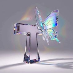 a glass figurine with a butterfly on it's back and wings spread out