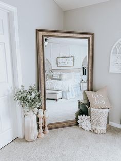 a large mirror sitting on top of a white rug