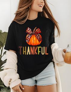 A fall themed T-shirt featuring a beautiful orange pumpkin with a bow and colorful 'thankful' lettering. Perfect for the autumn season, Thanksgiving, and harvest celebrations. Provides a cozy and festive vibe, ideal for anyone looking to add a touch of gratitude to their wardrobe.Great for a Fall lovers! Product features - Made from 100% ring-spun cotton for a lightweight and comfortable feel - Classic fit with crew neckline suitable for any occasion - Ethically grown and harvested US cotton for sustainability - Variety of fabric blends available for different color options - Tear-away label for added comfort and customization Care instructions - Do not dryclean - Machine wash: warm (max 40C or 105F) - Do not bleach - Tumble dry: low heat - Iron, steam or dry: low heat Fall Tshirt Designs, Thankful Pumpkin, Harvest Celebration, Fall Lovers, Patch Top, Autumn T Shirts, Orange Pumpkin, Fall Tee, Thanksgiving Outfit