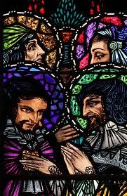 stained glass depicting jesus and mary in the center with other people around him, all looking at each other