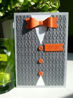 a card with an orange bow tie on it