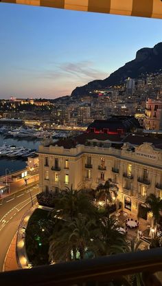 the city lights are on at night in monaco