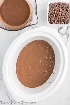 ingredients for chocolate cake in bowls on a marble counter