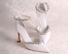 Step into modern sophistication with "MOLLY" Wedding Shoes for the modern bride. These Leather Bridal High Heels boast a contemporary design with D'Orsay Ankle Strap, elevating your bridal style. Adorned with silver crystals, these embellished shoes add a touch of glamour. Embrace the avant-garde elegance of "MOLLY" and make a statement on your special day, where tradition meets the latest trends. Brand: YvollaShoes® *  FIT TRUE TO SIZE *  Heel height: 9.5cm / 3.74inches *  Color: White (as show Bridal High Heels, High Heels Silver, Wedding Shoes For Bride, Shoes For Bride, Heels Silver, Embellished Shoes, Womens Wedding Shoes, Bride Shoes, Leather High Heels