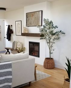 a living room filled with furniture and a fire place next to a wall mounted fireplace