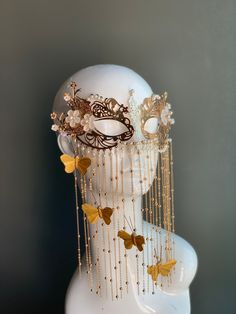 This elegant golden metal masquerade mask features dangling butterflies with floral notes and pearls. The mask is made out of comfortable and lightweight metal, great for long time wear! I N C L U D E D Mask comes with matching ribbons. S H I P P I N G -  Processed same day or within 24 hours.  1-2 day guaranteed delivery, add item to cart, click shipping tab for rates.  Pls leave a check out note with your need date & contact number  Msg for delivery time frames (Include your state/country) S I Butterfly Body Adornment, Masquerade Mask Stars, Fashion Themes Inspiration, Pearl Masquerade Mask, Masquerade Ball Gowns Elegant With Mask, Masquerade Mask Design, Star Themed Outfits, Black And Gold Masquerade Mask, Butterfly Masquerade Mask