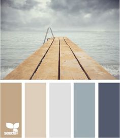 a wooden dock in the middle of water with clouds above and below it is a color palette