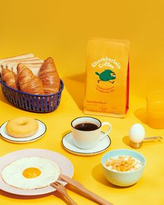 the breakfast is ready to be eaten with coffee and croissants on the table