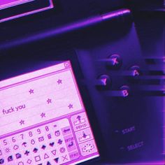 a computer keyboard sitting on top of a desk next to a purple screen with the words luck you