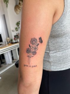 a woman with a tattoo on her arm that says grow in grace and a butterfly