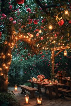 an outdoor dining area is lit up with candles and flowers on the table, surrounded by lanterns