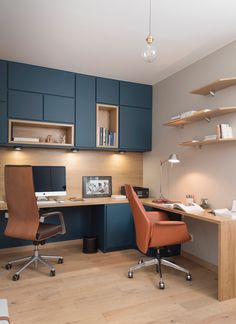 a home office with blue cabinets and wooden floors