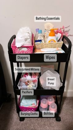 a black cart filled with lots of different types of baby products and items on top of it