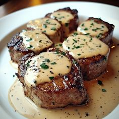 the steak is covered in gravy and garnished with parmesan cheese