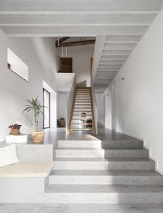 the stairs in this modern house are made of concrete and have been painted white with gray stripes