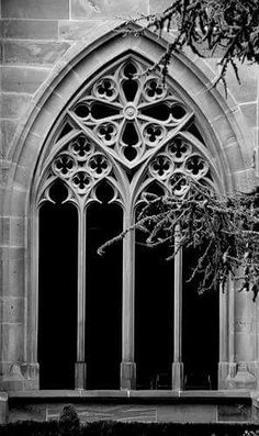 a black and white photo of an old church window