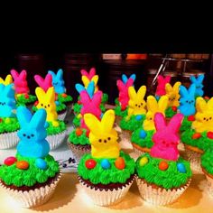 cupcakes decorated with colorful frosting and bunny ears