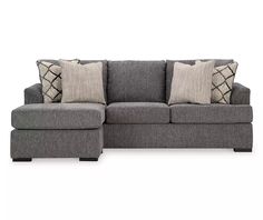 a gray couch with pillows on it