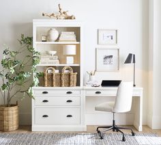 a white desk and chair in front of a bookshelf with pictures on the wall