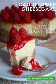 a piece of cheesecake on a plate with raspberries