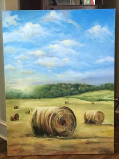 a painting of hay bales in a field