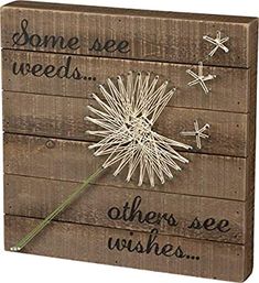 a wooden sign that says some see weeds others see wishes