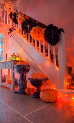 a staircase decorated for halloween with pumpkins and decorations