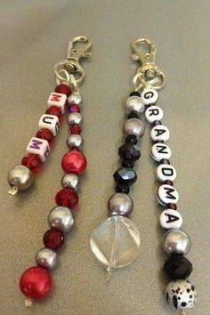 three beaded key chains with charms attached to them