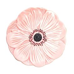 a pink flower shaped dish with black accents