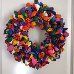 a colorful wreath is hanging on the wall