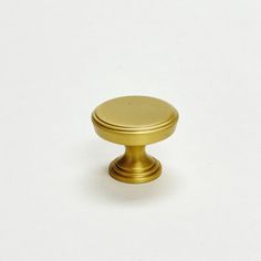 an antique brass cabinet knob on a white background