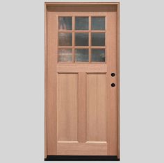 a wooden door with glass panels on the top and bottom panel, in front of a gray background