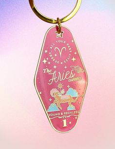 a pink keychain with an angel on it