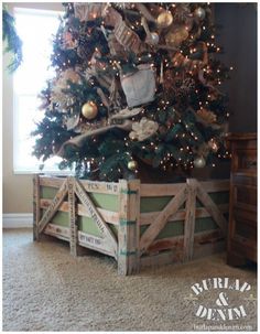 a small christmas tree in a wooden crate with ornaments on top and lights around it