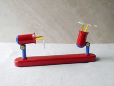 two red and blue toothbrush holders on a white surface