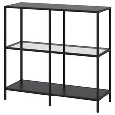 a black shelf with three glass shelves on each side, and one shelf below it