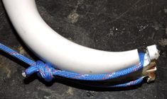 a close up of a white and blue rope connected to an object