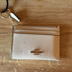 Coach mini ID wallet
-Cream leather with gold hardware 
-comfortably holds up to 3/4 cards in each slot 
-zipper pouch in top to hold coins, and has jump ring connected to hold keys or other items 
-small dark stains on leather, but easily could be removed
-So so cute for an upgraded wallet! 
#coach #wallet #winter2024 #trending #cute Id Wallet, Coach Wallet, Dark Stains, Jump Rings, Zipper Pouch, Wallets For Women, Gold Hardware, Women's Accessories, Pouch