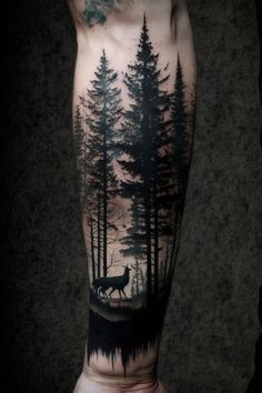 a man's leg with trees and a wolf on it