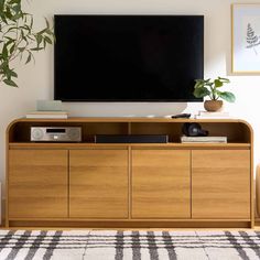 a flat screen tv mounted to the side of a wooden cabinet