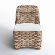 a wicker chair with a white cushion