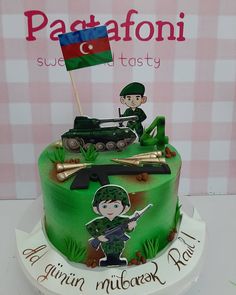 a green cake with a soldier on top and a flag sticking out of the middle