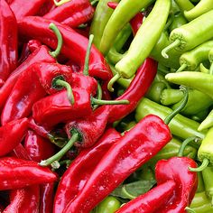 red and green peppers are piled on top of each other